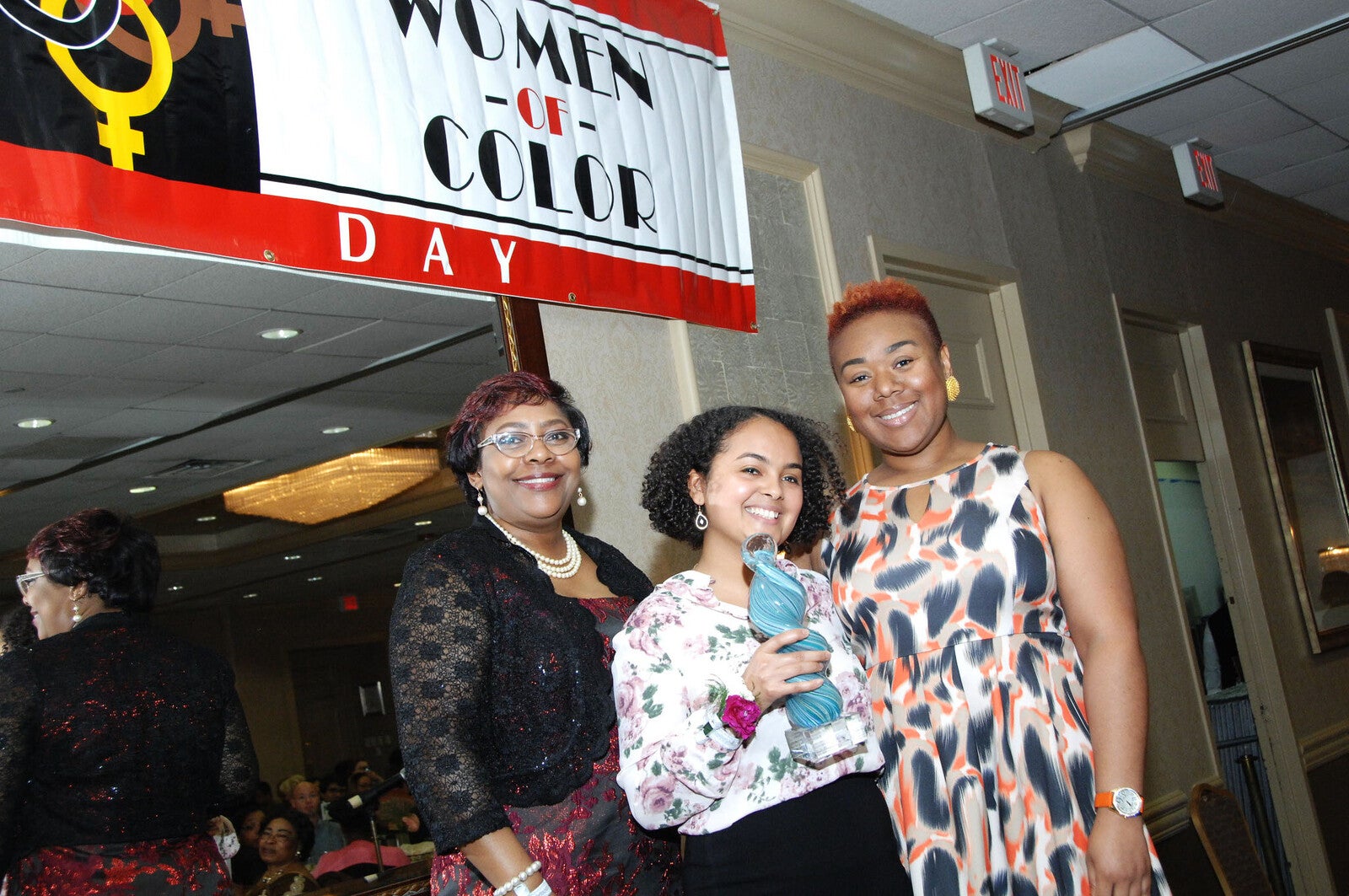 AARC Undergrad Award recipient holds award next to two attendees