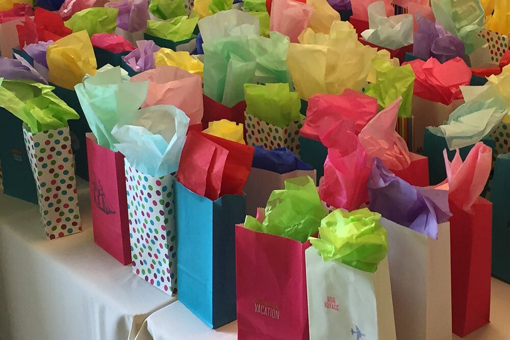 colorful gift bags lined up on table